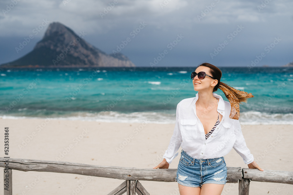 cheerful woman in sunglasses on the island holiday