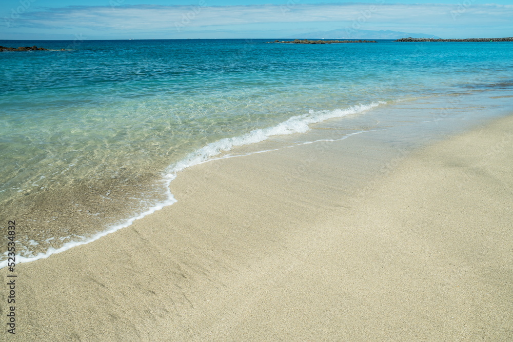 Ocean foam covering beautiful long sandy beach. Ocean foam covering beautiful long sandy beach.