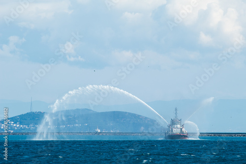 A rescue ship with a jet of water cannons. A coastal rescue ship is spewing water. fire ship at sea