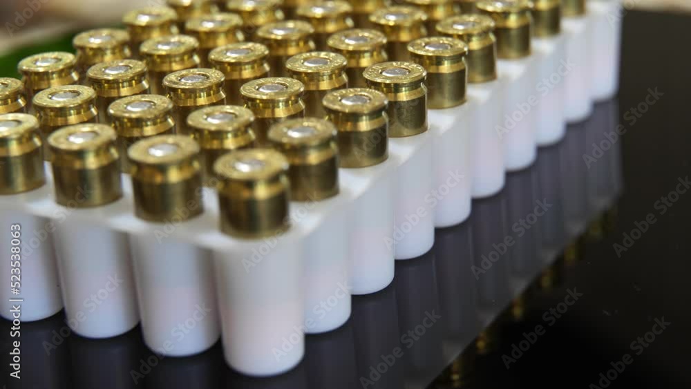 Rows in a box of 9MM bullet ammunition - turning close up Rows in a box of 9MM bullet ammunition - turning close up