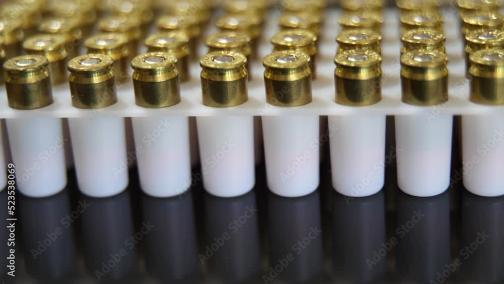 Rows of 9MM gun ammunition bullets - macro turning Rows of 9MM gun ammunition bullets - macro turning