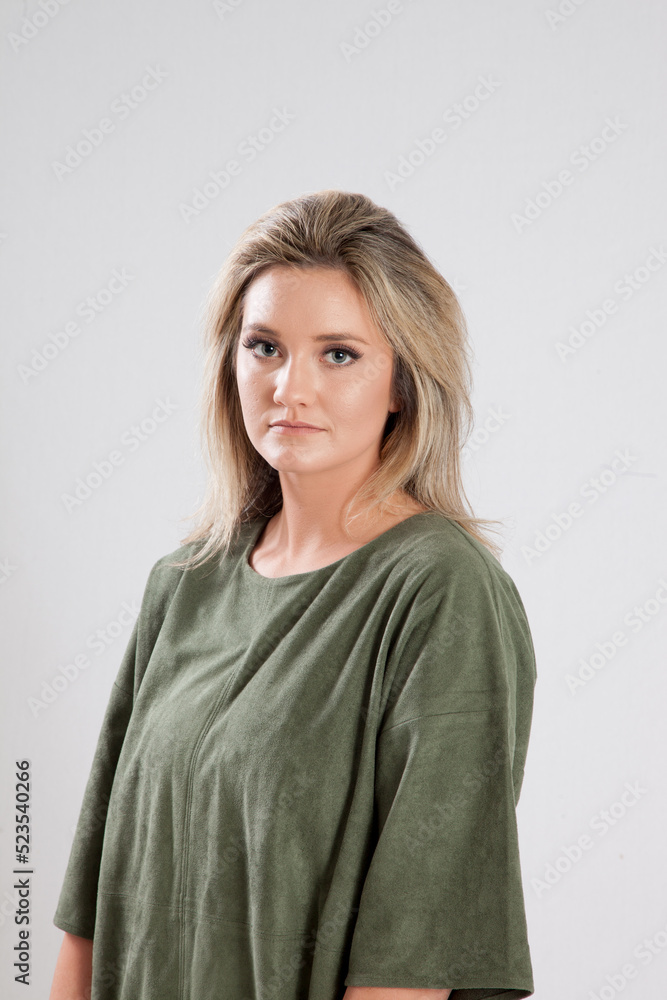 Lovely Blond in a green shirt with a thoughtful expression