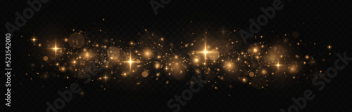 The dust sparks and golden stars shine with special light. Glitter bokeh lights is isolated on a transparent background. Sparkling space magical dust particles.