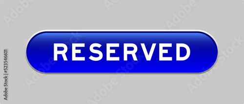 Blue color capsule shape button with word reserved on gray background
