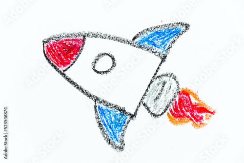 Colorful oil pastel hand drawing in spaceship or rocket shape on white paper background