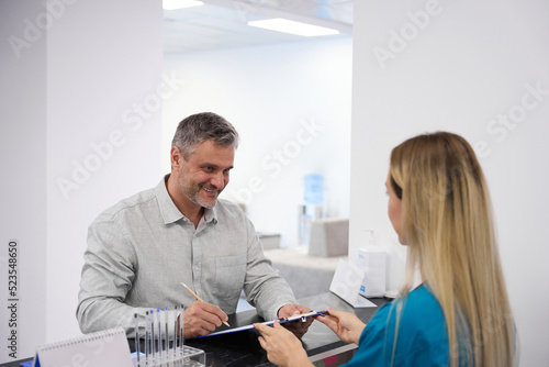 Doctor gives the patient to fill out a questionnaire