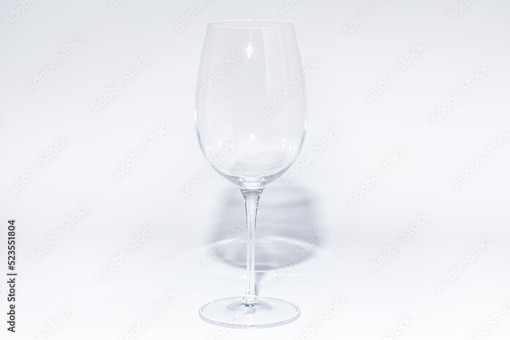 Empty glass of wine on white background