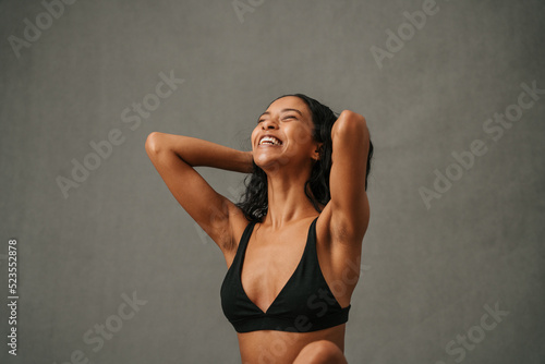 Very excited African American female putting her hands through her hair photo