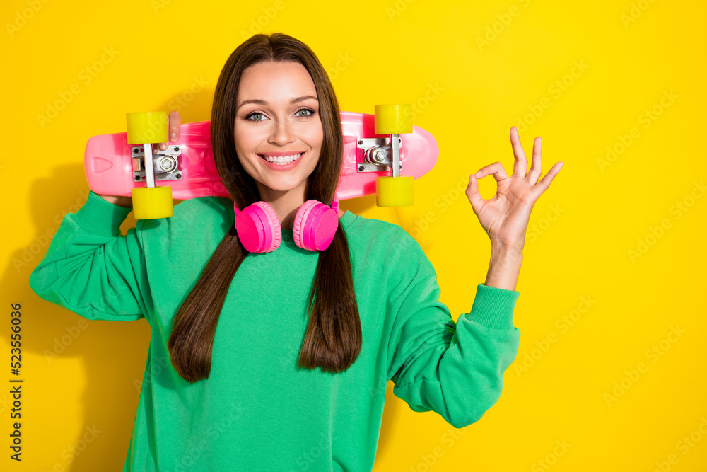 Portrait of charming positive person arm fingers show okey symbol isolated on yellow color background Portrait of charming positive person arm fingers show okey symbol isolated on yellow color background
