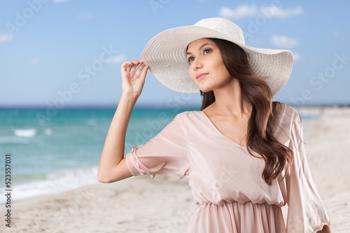 Young happy woman enjoying the resort on the beach