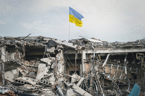 destroyed building. view of the ruins. wreckage of the building and the Ukrainian flag