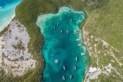 Drone aerial view of anchored sailing yacht in emerald Caribbean sea, Stocking Island, Great Exuma, Bahamas. photo