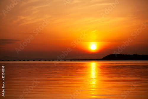 orange sunset on the sea beyond the bridge