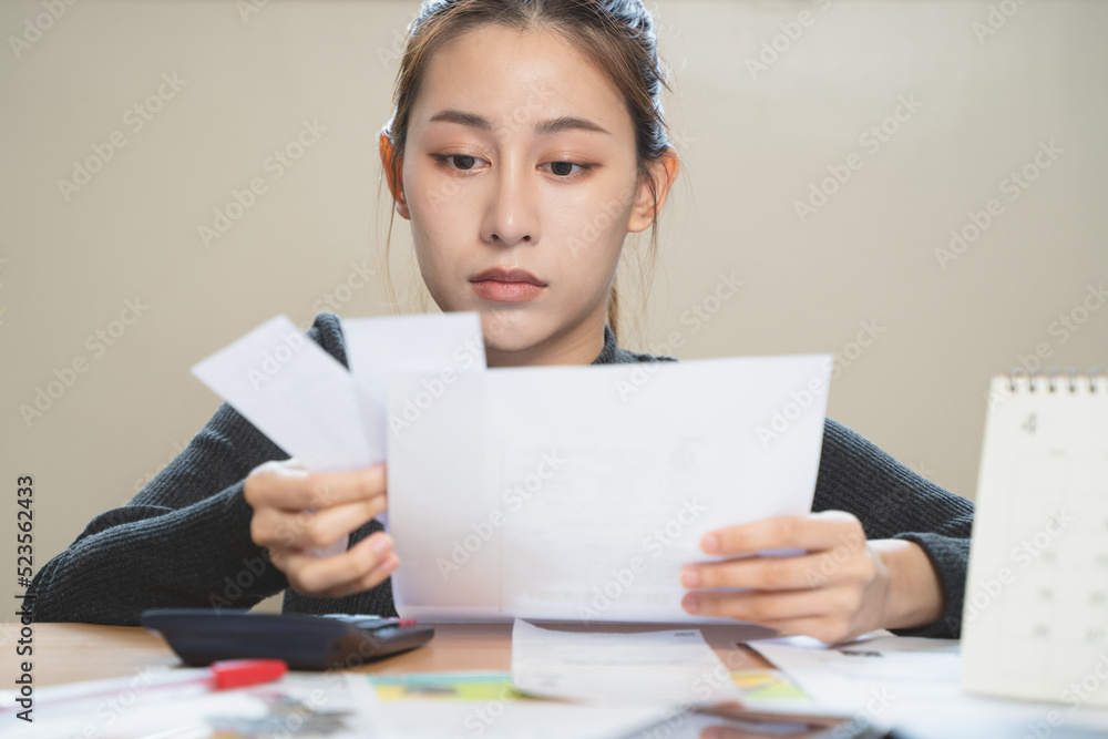 stressed young asian woman trying to find money to pay credit card debt. stressed young asian woman trying to find money to pay credit card debt.