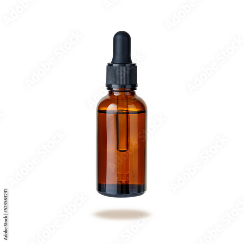 Dark brown glass bottle of face serum or essential oil or pharmaceutical tincture isolated on white