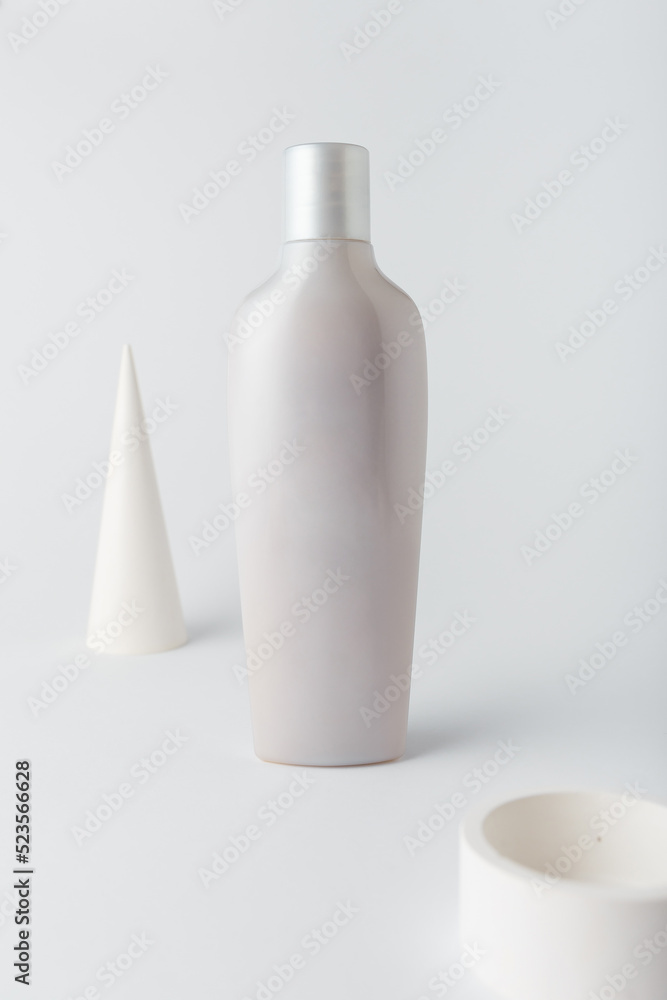 Hair conditioner or shampoo bottle on white background. Care cosmetics, concrete decor. Mock up, blank template, no brand, no label Hair conditioner or shampoo bottle on white background. Care cosmetics, concrete decor. Mock up, blank template, no brand, no label