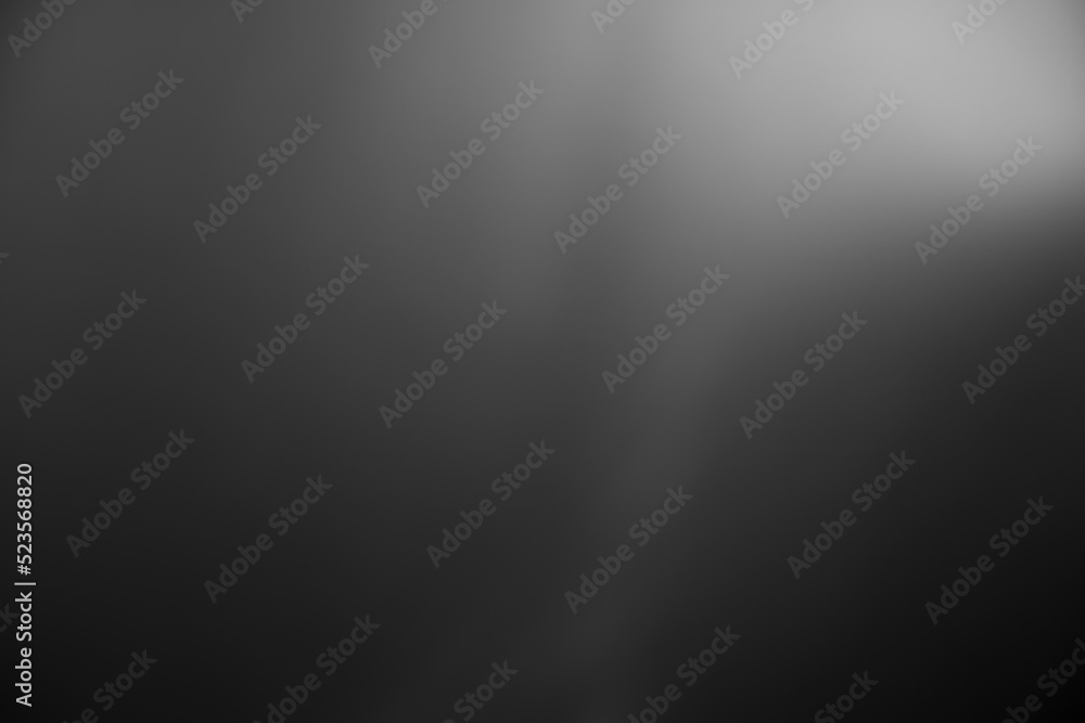 Dark black and gray blurred gradient background has a little abstract light. Dark black and gray blurred gradient background has a little abstract light.