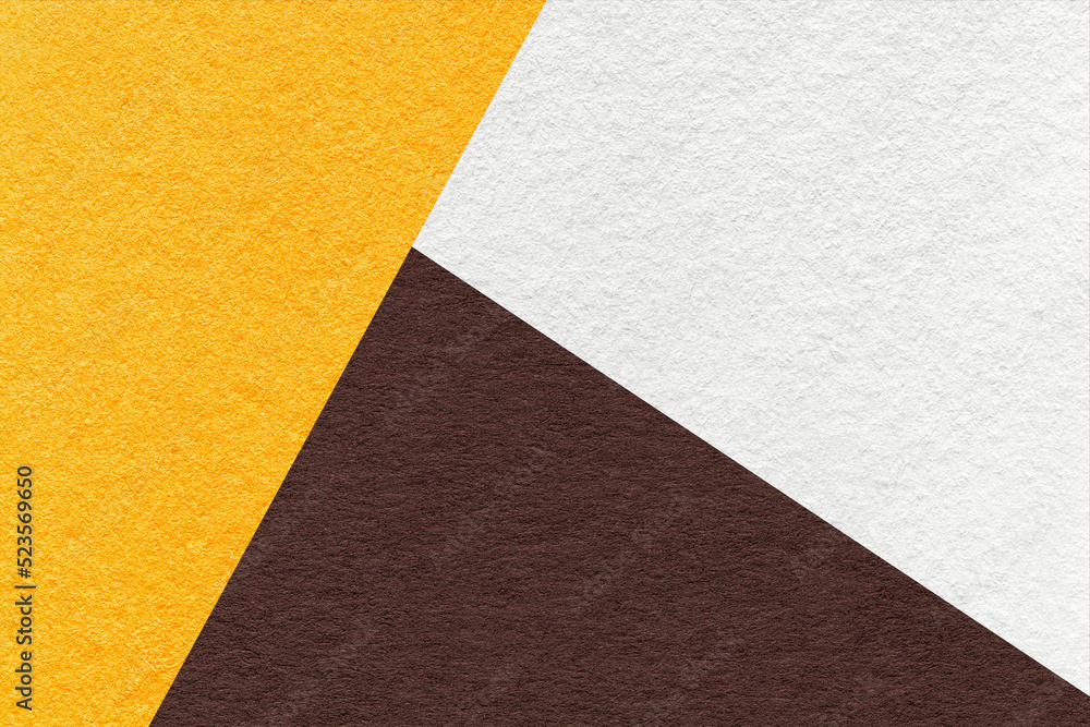 Fototapeta premium Texture of craft white, yellow and dark brown shade color paper background, macro. Vintage abstract cardboard