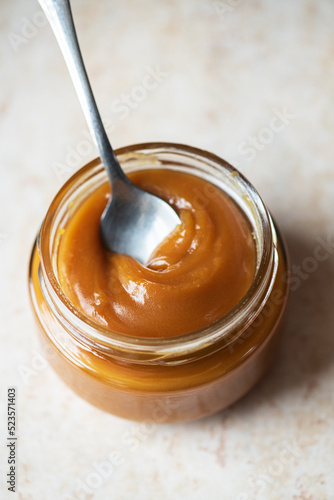 Homemade creamy caramel in a jar. Close up.