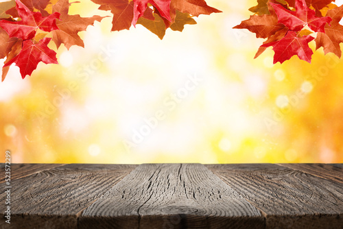 Autumn background with maple leaves and empty wood shelf. Fall background with copy space for product display