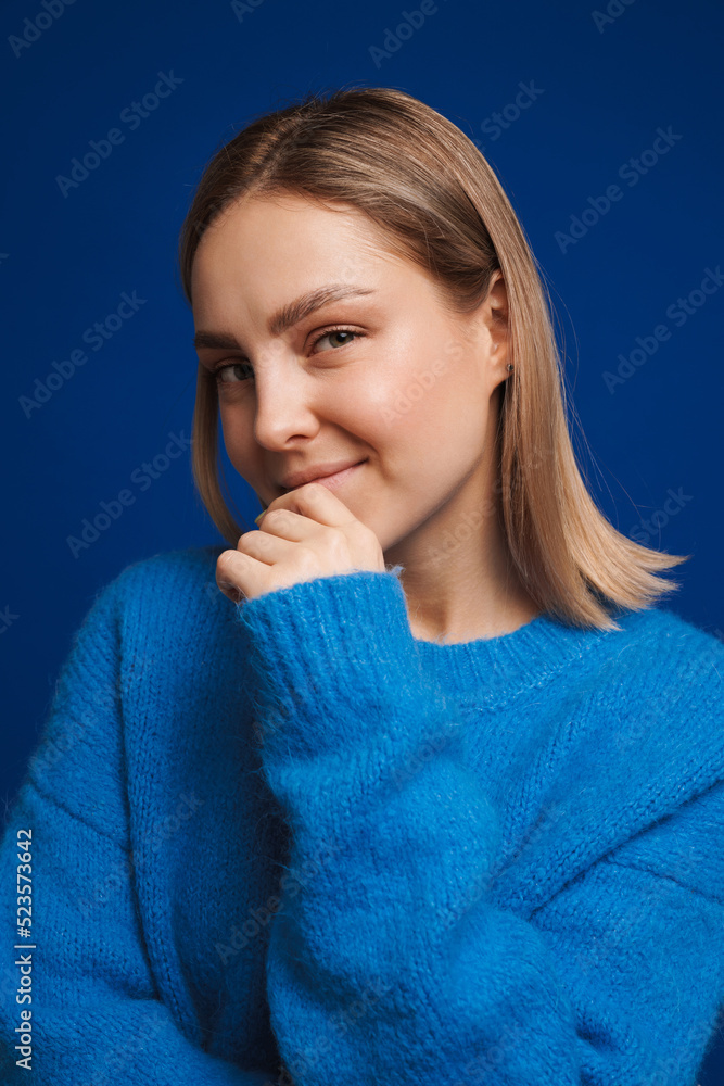 Young white happy woman wearing sweater smiling and looking at camera Young white happy woman wearing sweater smiling and looking at camera