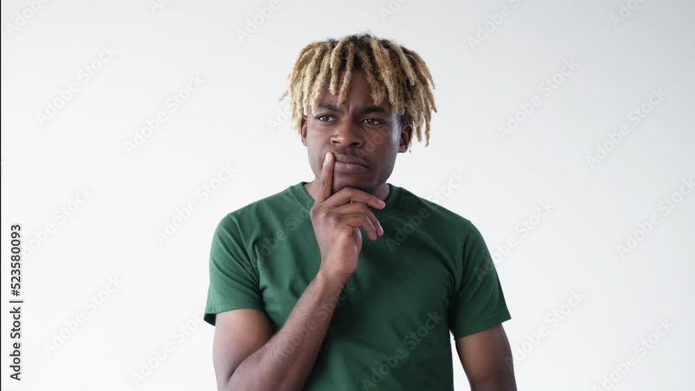 Guess problem. Thoughtful man. Meme expression. Puzzled black guy holding finger on cheek shifting eyes isolated white looped video. Guess problem. Thoughtful man. Meme expression. Puzzled black guy holding finger on cheek shifting eyes isolated white looped video.