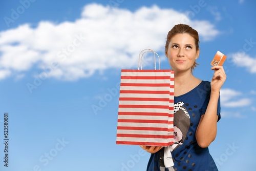 Happy young teen woman holding credit card