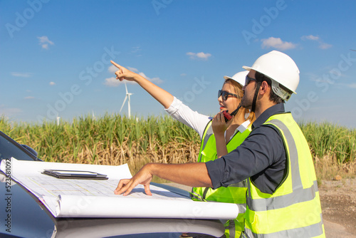 engineer team working in wind turbine farm. Renewable energy with wind generator by alternative energy concept.