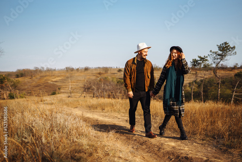 Lovely hipster couple resting in nature. People, lifestyle, relaxation and vacations concept. Autumn Fashion, style concept.