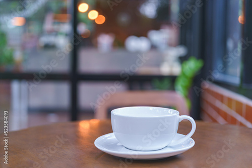 White coffee cup placed on the table. Coffee shop background.