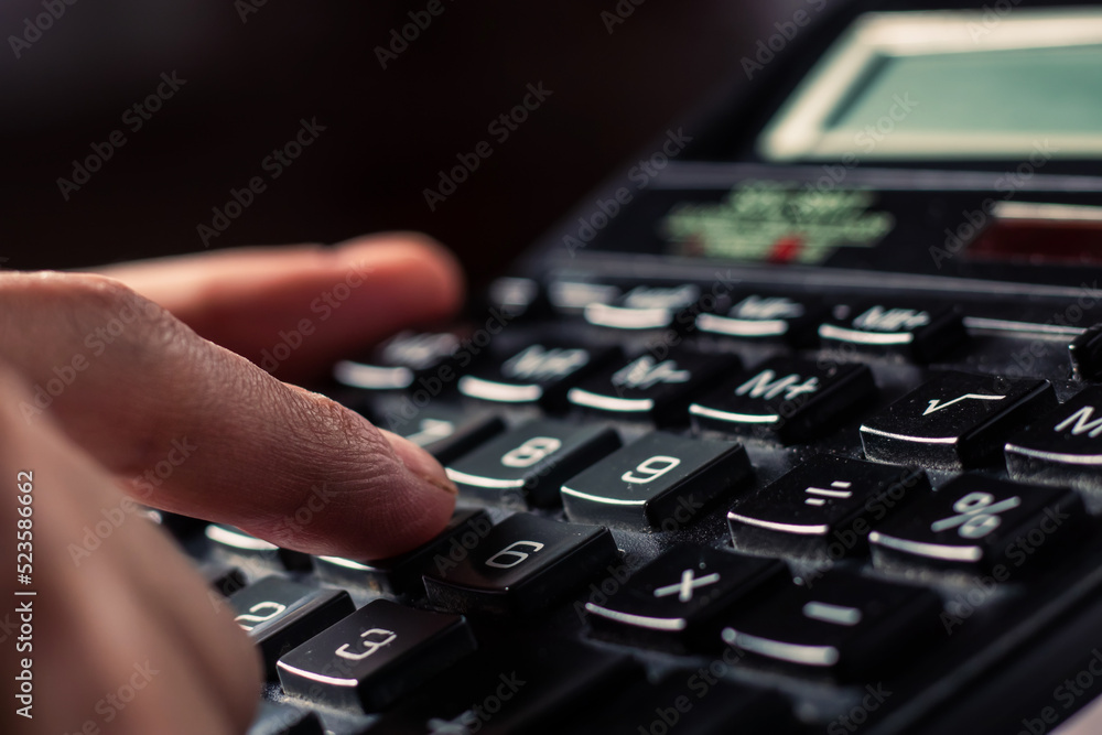 Obraz premium Close up businessman hand using calculator calculate about finance accounting at coffeeshop outdor.