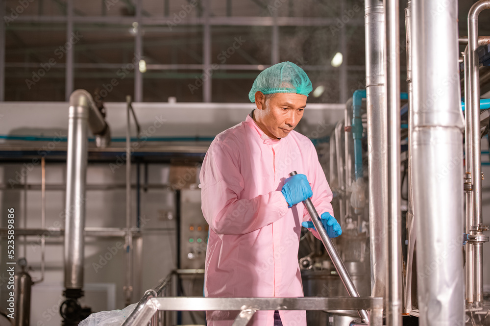 Asian man employee working in food Factory industry Asian man employee working in food Factory industry