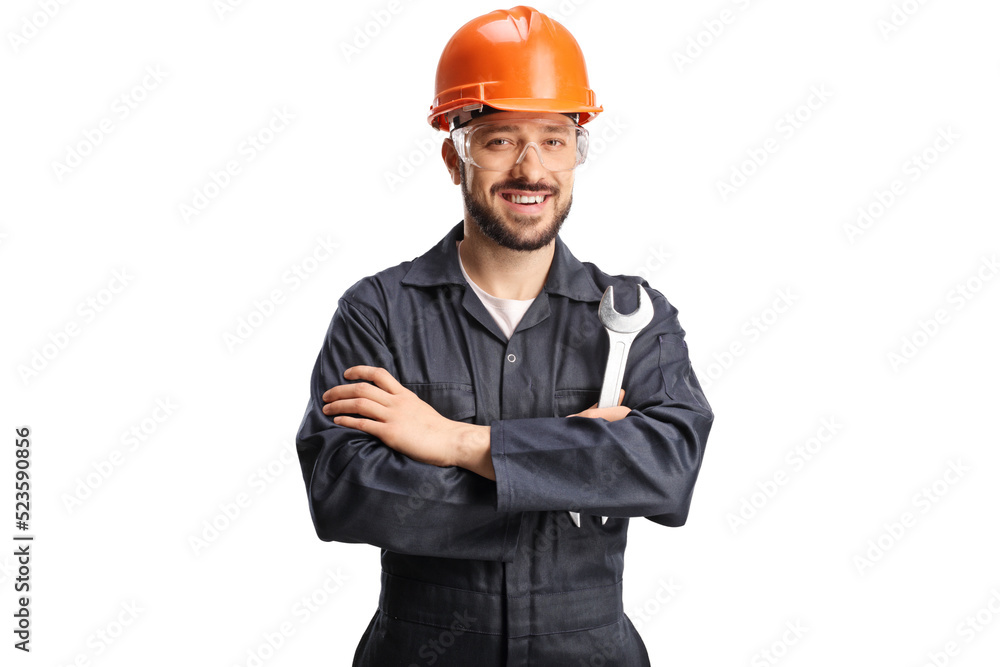 Smiling young worker with an orange hardhat holding a wrench Smiling young worker with an orange hardhat holding a wrench