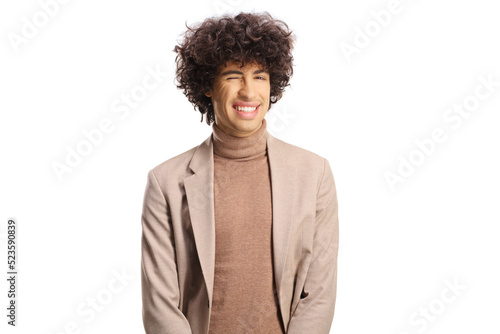 Young man with curly hair winking