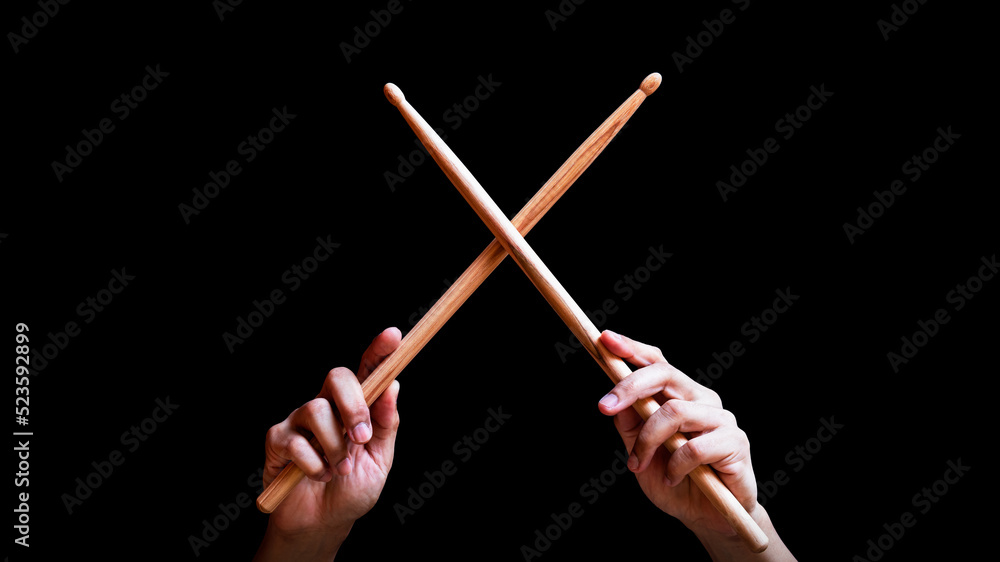 Fototapeta premium male drummer hands holding drumsticks in x shape. isolated on black