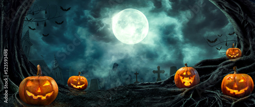 Foto Pumpkin zombie Rising Out Of A Graveyard cemetery and church In Spooky scary dark Night full moon bats on tree