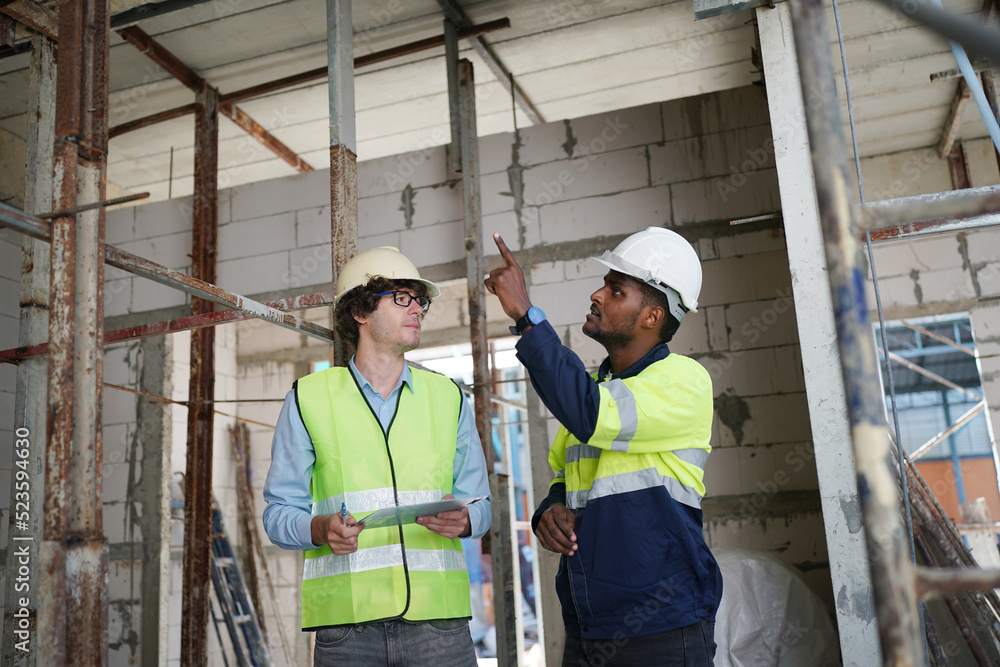 Architect and construction engineer or surveyor discussion plans and blueprints Architect and construction engineer or surveyor discussion plans and blueprints