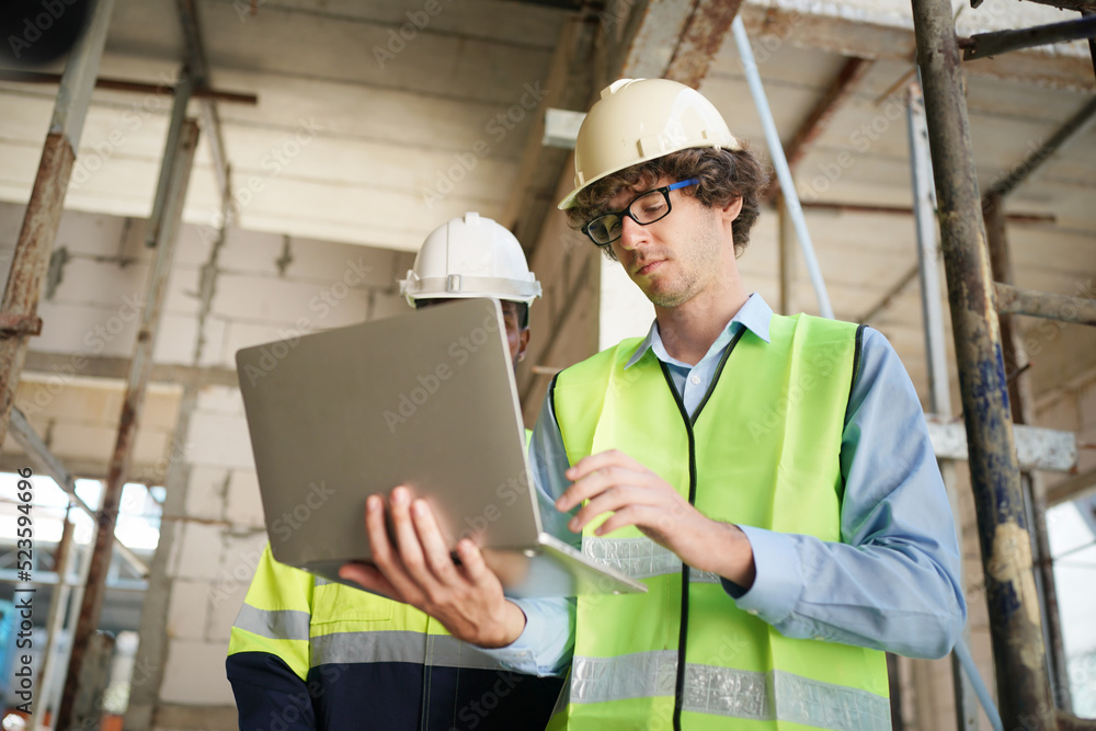Architect and construction engineer or surveyor discussion plans and blueprints Architect and construction engineer or surveyor discussion plans and blueprints