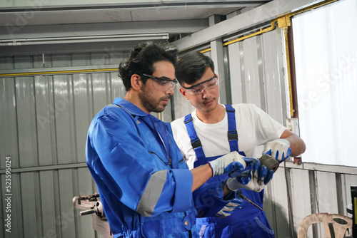 Workers changing and repair part of wheels at the car service