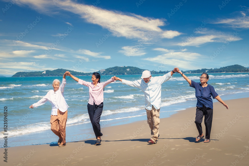 Group of asian seniors man and women happy time on the beach Group of asian seniors man and women happy time on the beach