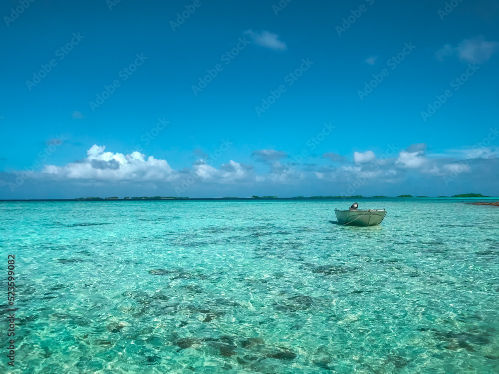 Turquoise sea water island landscape. Blue sky and fishing boat. Beautiful tropical beach abstract texture background. Exotic summer resort, vacation, paradise holiday travel concept. Relaxing nature