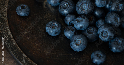 Blueberries on a table. Blueberries on a dark aged background.