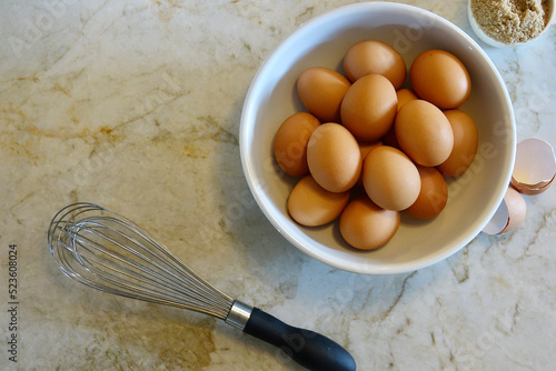 a dozen eggs in a brown bowl