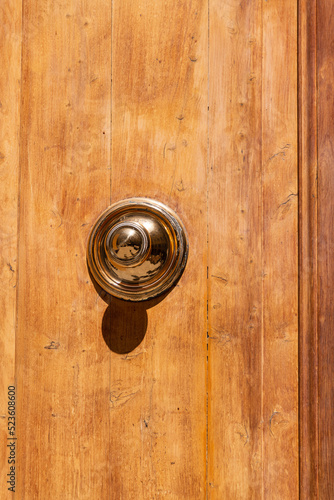 Golden Knob On A Wooden Door