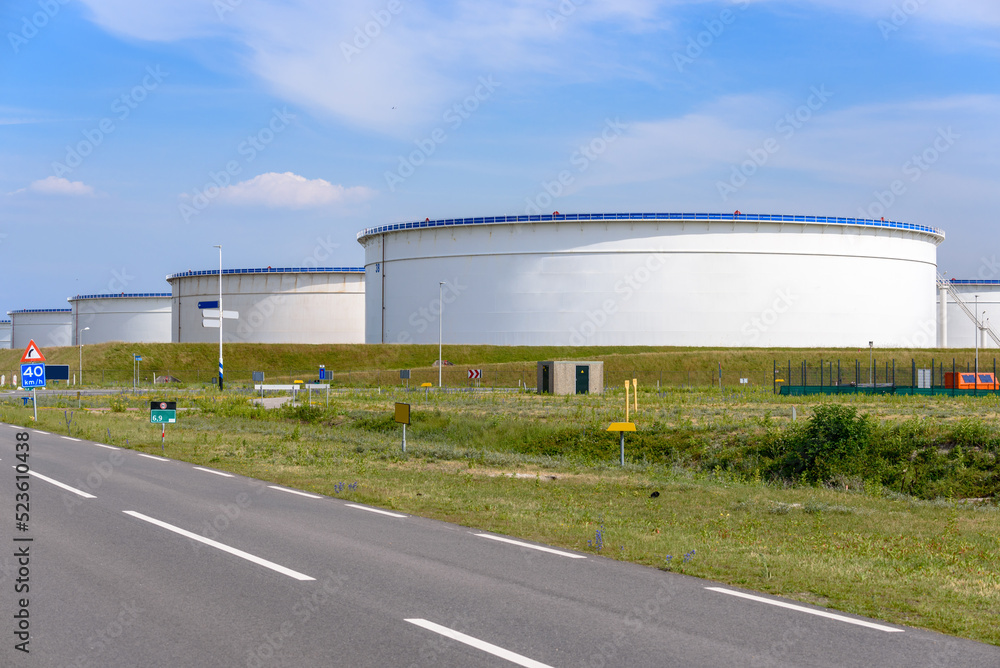 Large crude oil storage tanks in a oil terminal on a sunny summer day