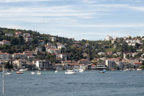 View of moored yachts on Bosphorus and Bebek neighborhood on European side of Istanbul. It is a sunny summer day. Beautiful travel scene.
