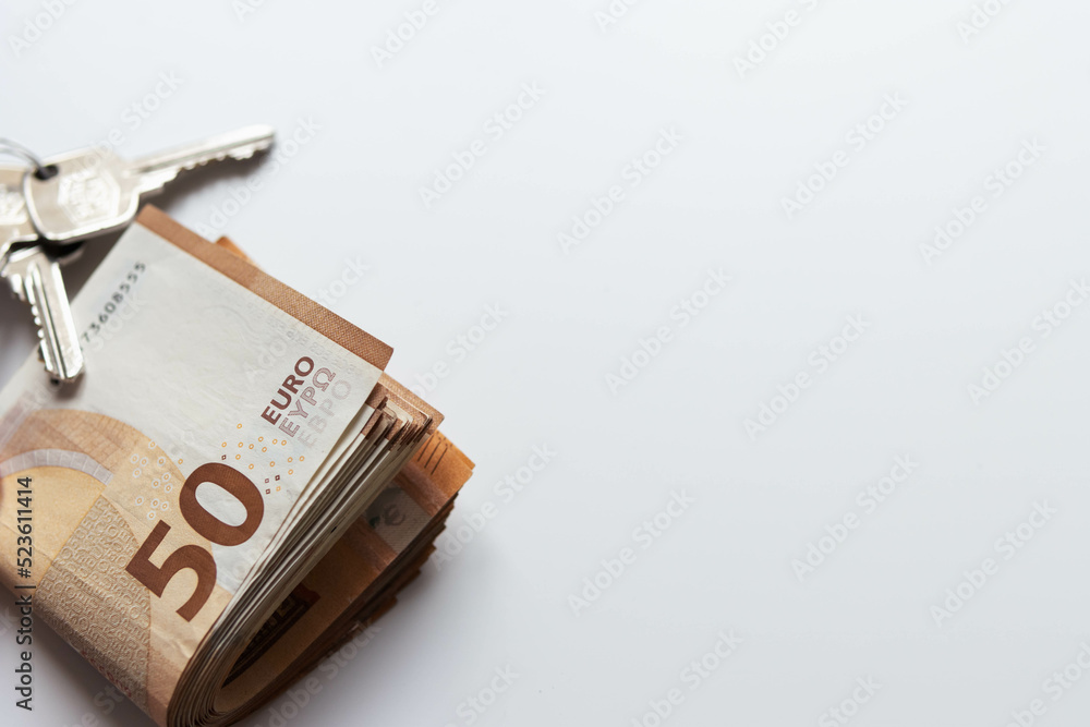 isolated on white background euro banknotes of 50 folded and next to the keys lie with the right place for the inscription isolated on white background euro banknotes of 50 folded and next to the keys lie with the right place for the inscription