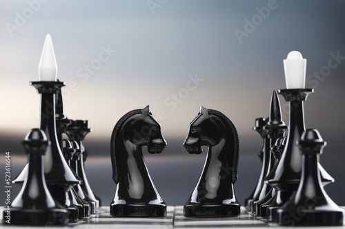 Shiny chess figures standing on wooden chessboard. Intellectual duel and tactical battle symbol. Strategy planning and corporate leadership concept.