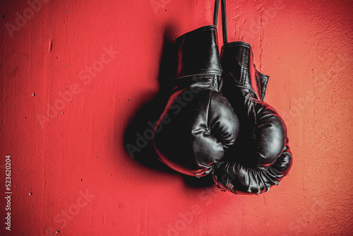 Boxing Gloves hanging on the red vintage wall © Spanic