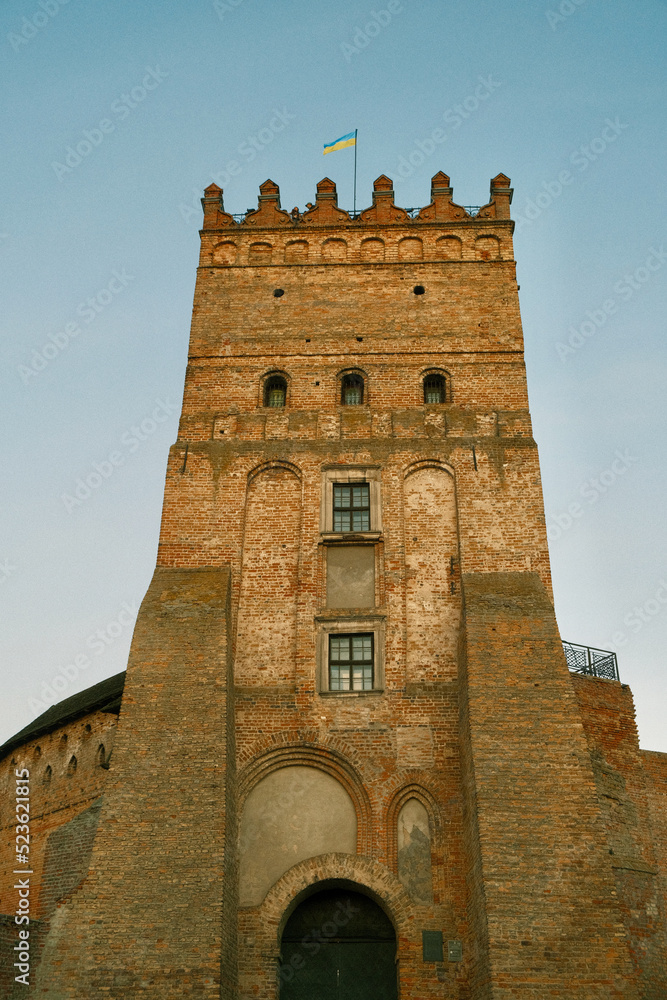 Walls and tower of an ancient castle. Brick walls and watchtower of an ancient castle. History - ancient Ukrainian castle Walls and tower of an ancient castle. Brick walls and watchtower of an ancient castle. History - ancient Ukrainian castle